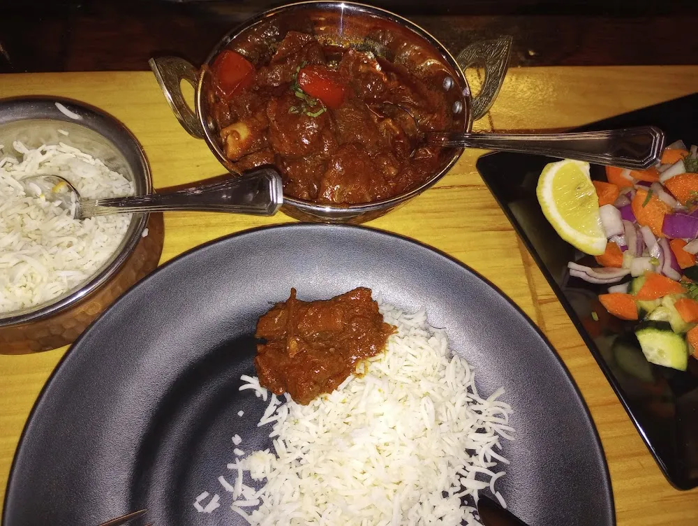 Goat Curry on a Bed of Basmati Rice and a Side Salad